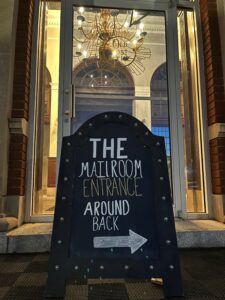 The Mailroom Speakeasy entrance around back sign
